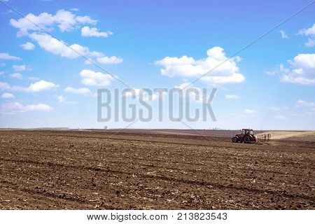 agriculture arable land field with tractor machine working