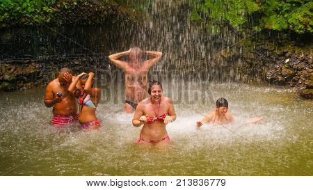 Soufriere, Saint Lucia - May 12, 2016: The tourists swimming at the waterfall at the Botanical Gardens in Saint Lucia at island at Caribbean sea