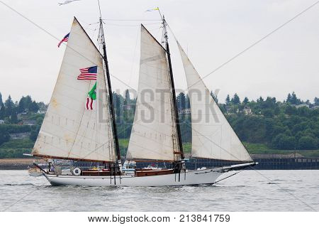 Small gaff rigged sailng schooner underway in Tacoma Tall Ships Festival 2005. Calm waters overcast sky