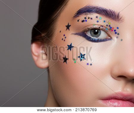 The Beautiful Girl With Creative Fashionable Cosmetics On A Face. Spangles And Stars, Color And Brig