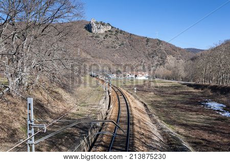 Iberian gauge railway track between Leon and Gijon, on its way through La Pola de Gordon, Leon Province, Spain. In the background can be seen the town of Puente de Alba