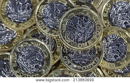 British Currency - One pound bimetallic coins in a pile