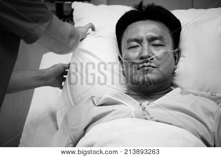 A sick Asian man in a hospital