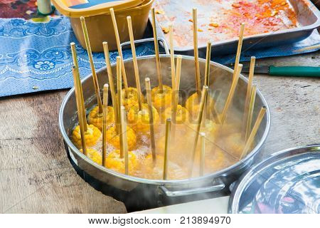 Steamed fresh corn with stick  boiling on the streeet of Cebu city. Philippines.