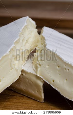 Close Up Of Camembert Cheese. Brie With Coarse Edge Broken Into Pieces Cremy And Delicious.