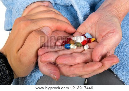 Caregiver giving medication to her senior patient