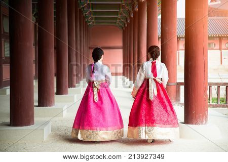 Asian Korean woman dressed Hanbok in traditional dress walking in Gyeongbokgung Palace in Seoul South Korea.