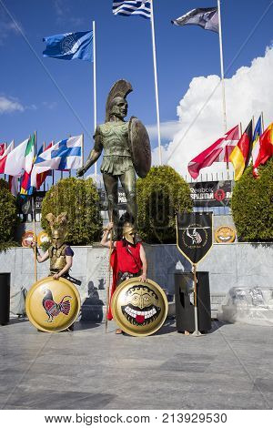 couple of warriors wearing ancient spartan armor under the statue of Leonidas in Sparta during Spartan race 2017