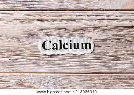calcium of the word on paper. concept. Words of calcium on a wooden background.