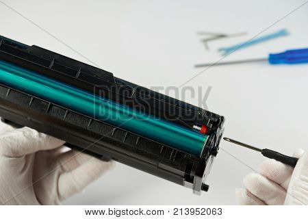 Repair printer service concept. Man in gloves checking printer toner