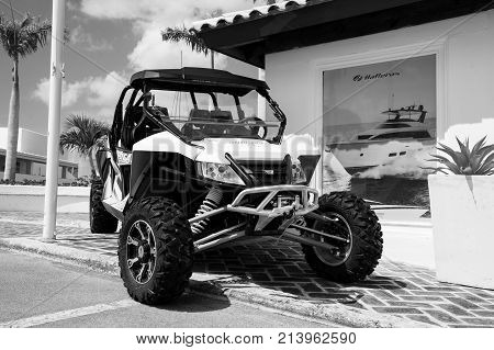 La Romana Dominican Republic-January 16 2016: big cool sport open car of arctic cat brand with wheels and hull white and green color parking sunny day outdoor near building