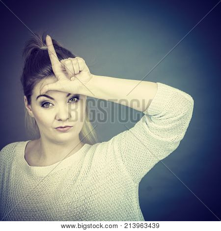 Woman Showing Loser Gesture With L On Forehead