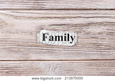 Family of the word on paper. concept. Words of Family on a wooden background.