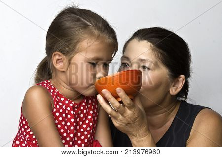 Affectionate grandmother and her cute little granddaughter