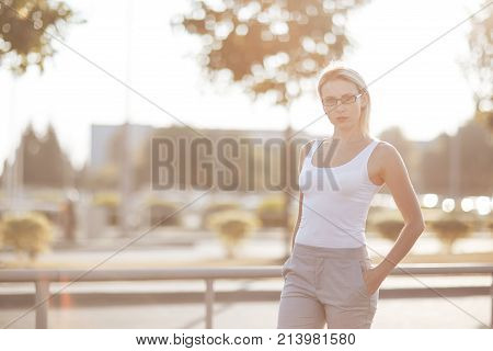 Long hair blonde in glasses at sunset