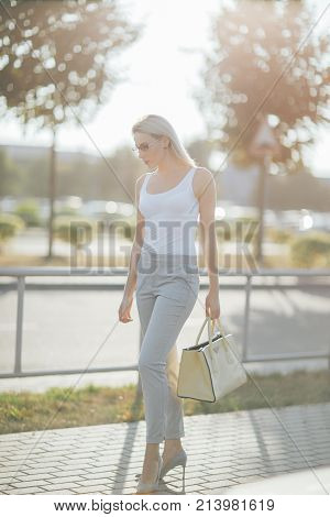 Portrait of a long hair blonde woman in glasses at sunset