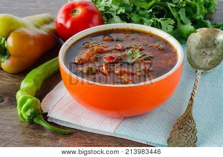 Bowl of traditional soup Borscht on table