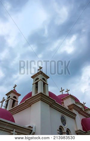 Close up roff and crosses of the Greek Orthodox Church of the Seven Apostles in Capernaum in Israel