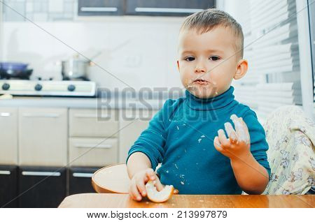 Baby In The Kitchen Eagerly Eating The Delicious Cream Horns, Vanilla Cream