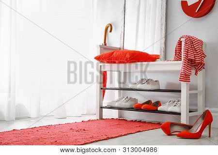 Stylish Hallway Interior With Shoe Rack And Rug. Space For Text