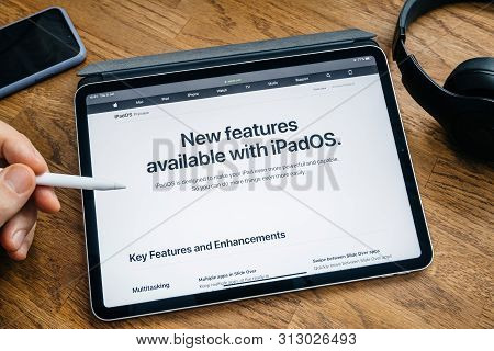 Paris, France - Jun 6, 2019: Man Reading On Apple Ipad Pro Tablet About Latest Announcement Of At Ap