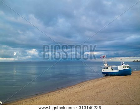 Fishing Boat On Baltic Sea Coast. Stormy Weather. Mechelinki, Poland, Pucka Bay.
