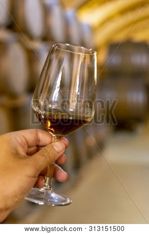 Tasting Of Fortified Dry Or Sweet Marsala Wine In Vintage Wine Cellar With Old Oak Barrels In Marsal
