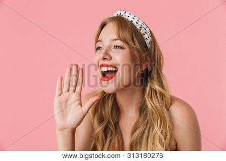 Image of attractive young woman with long curly hair calling or screaming while looking at copyspace isolated over pink background