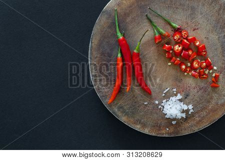 Purple Thai Eggplants And Hot Chili Peppers On A Green Plate On A Black Background. Asian Food.