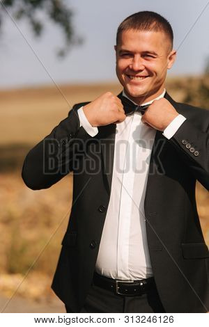Handsome Groomm Dressed A Tie Bow. Wedding Day. Man Outside. Young Man Smile
