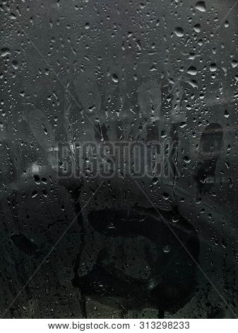 A Hand Print On Glass (car Window ) With Water Drops Of Heavy Rain In Lonavala (india)