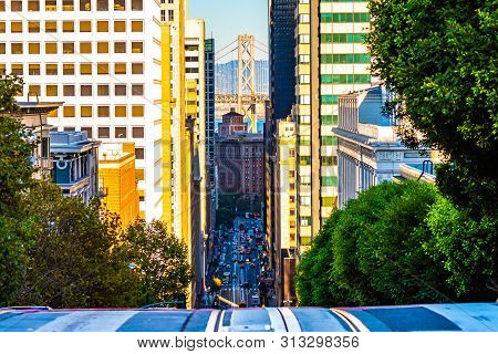 City Street View In San Francisco, California Uphill Looking Down Between Buildings And Other Archit