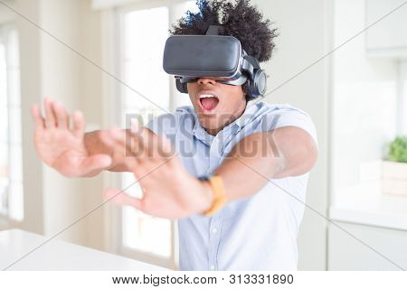 African amaerican man having fun playing with virtual reality glasses