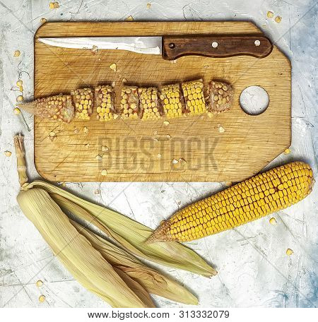Shucked And Cleaned Sweet Corns On Cutting Board. Sweet Corns On Desk.