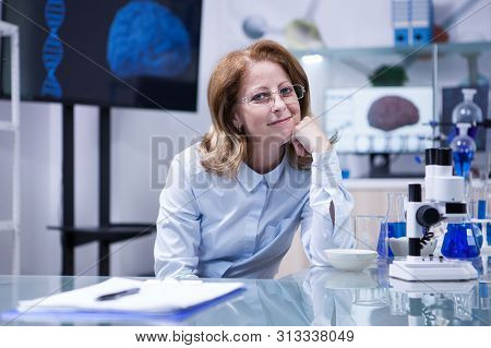 Portrait Of Middle Age Scientist Thinking About Her Career At Her Office In A Hospital Laboratory