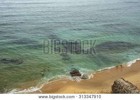 Oceanfront. Depicted: Turquoise Ocean Water, Sandy Beach And Rare Swimsuits. The View From The Top. 