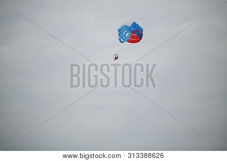Riding On A Parachute Behind A Boat Among The Popular Beach Activities. One Of The Most Popular Sea 