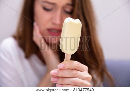 Portrait Of A Woman With Sensitive Teeth And Cold Ice Cream
