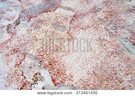 Undulatory Texture Of White Calcite Stalactites Covering A Cascade Of Terraced Baths In Pamukkale, T