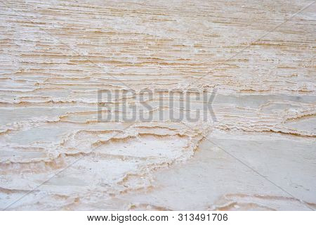 Undulatory Texture Of White Calcite Stalactites Covering A Cascade Of Terraced Baths In Pamukkale, T