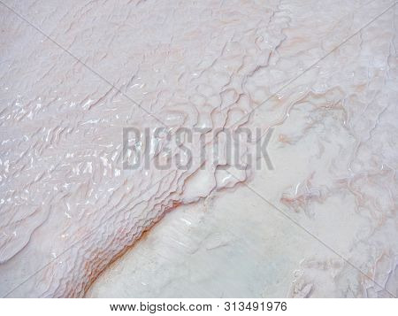Undulatory Texture Of White Calcite Stalactites Covering A Cascade Of Terraced Baths In Pamukkale, T