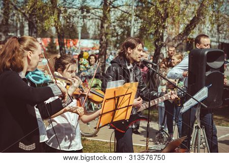 Russia, Siberia, Novokuznetsk - May 9, 2019: Musicians Sing Songs On The Street On Victory Day