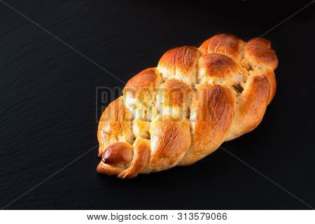 Homemade Food Concept Fresh Baked Bread Braid Challah Dough On Black Slate Stone With Copy Space