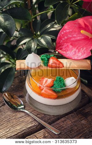 Panakota Dessert With Strawberry Pieces On A Wooden Board