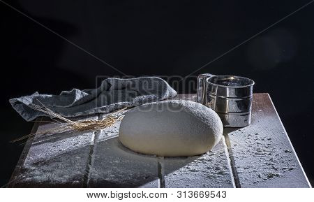 Risen  Yeast Dough For Bread Or Pizza On A Floured Surface, 45 Angle Shoot With Hard Light Selective