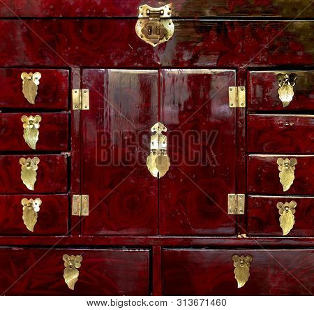 Detailed Close Up Of A Red Handcrafted Jewellery Box With Golden Pulls