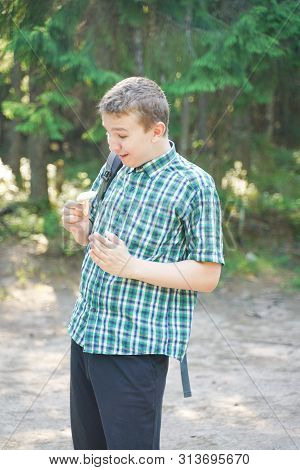 Teenager Boy With Mushroom In The Forest In Summer Day