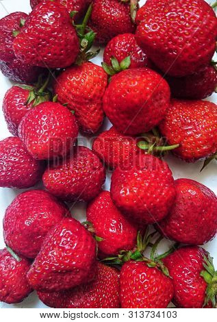 Bright Red Ripe Strawberries On A Light Background