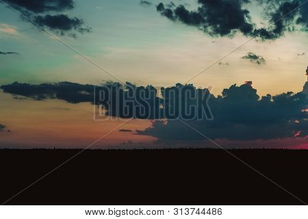Evening Sky At Sunset Background. Dark Clouds Hanging Above Horizon. Majestic Cloudscape In Blue, Or