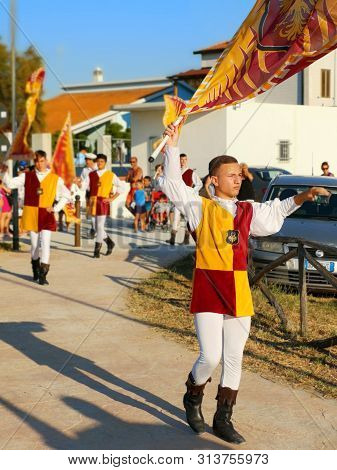Puglia, Italy, 20 July 2019 - Young Flag Wavers March Throgh The Streets Of Puglia .